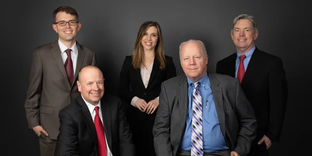 Group photo of Dugan, McKissick and Longmore partners.